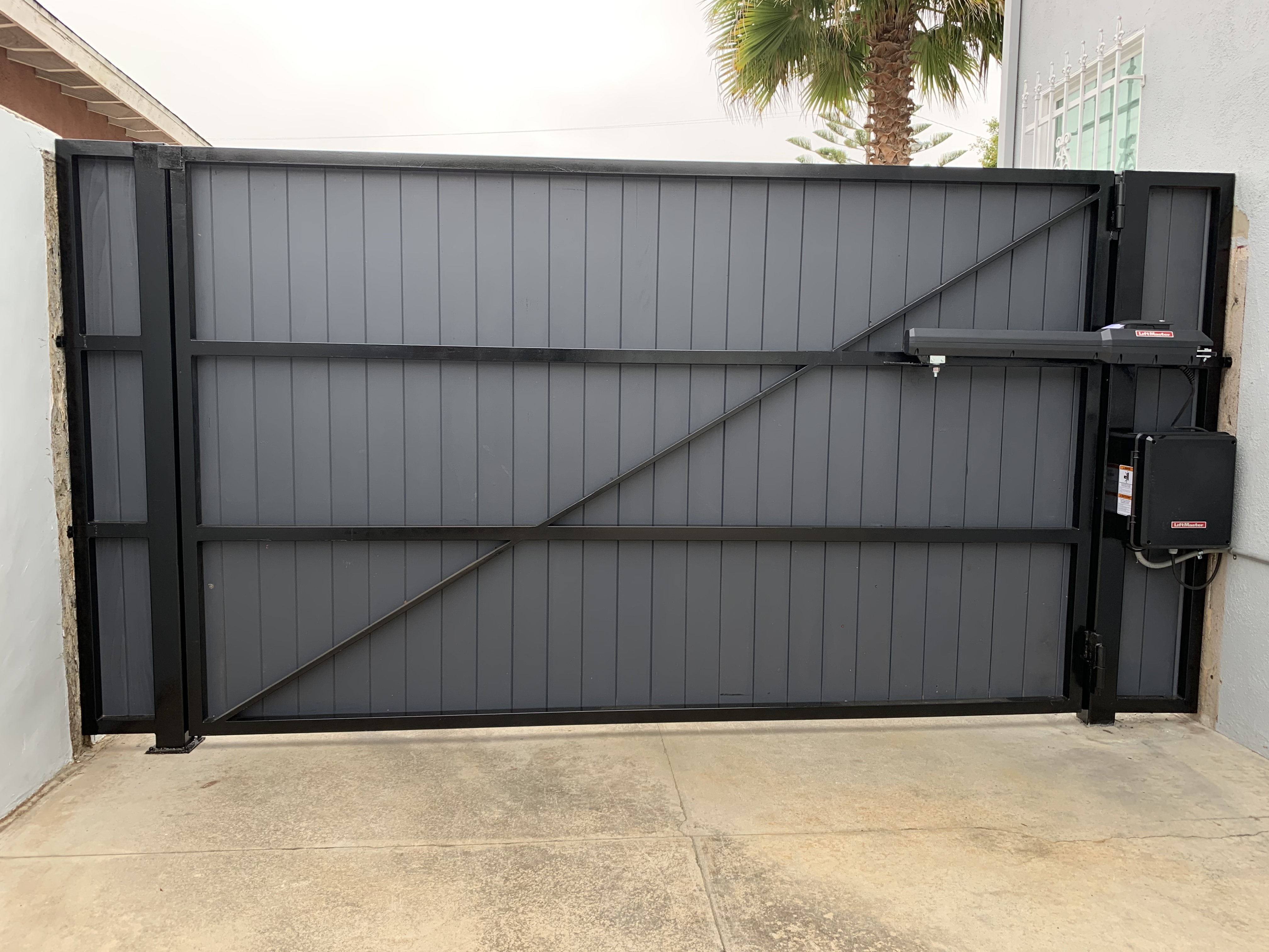 Culver City, Los Angeles Steel frame automatic motorized driveway gate tongue and groove redwood