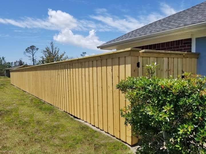 Board-on-board wood privacy fence with cap and trim in Panama City Beach, FL